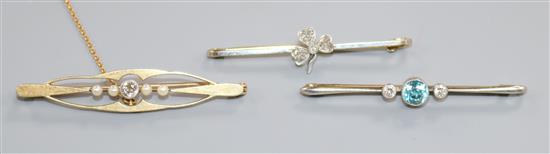 Two early 20th century 15ct gold and gem set bar brooches and a yellow metal, blue zircon and diamond set bar brooch.